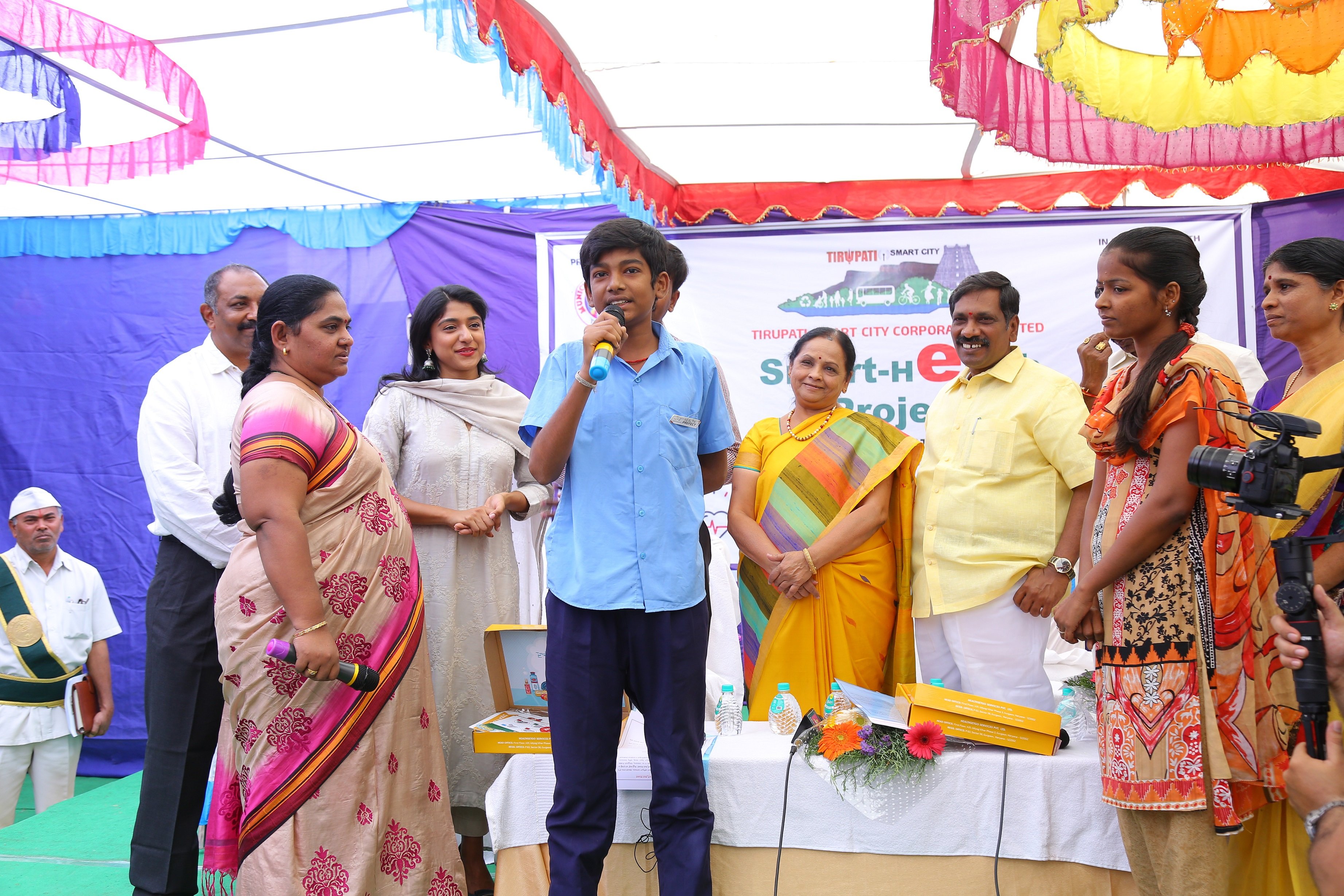 A young person presenting surrounded by a group of onlookers