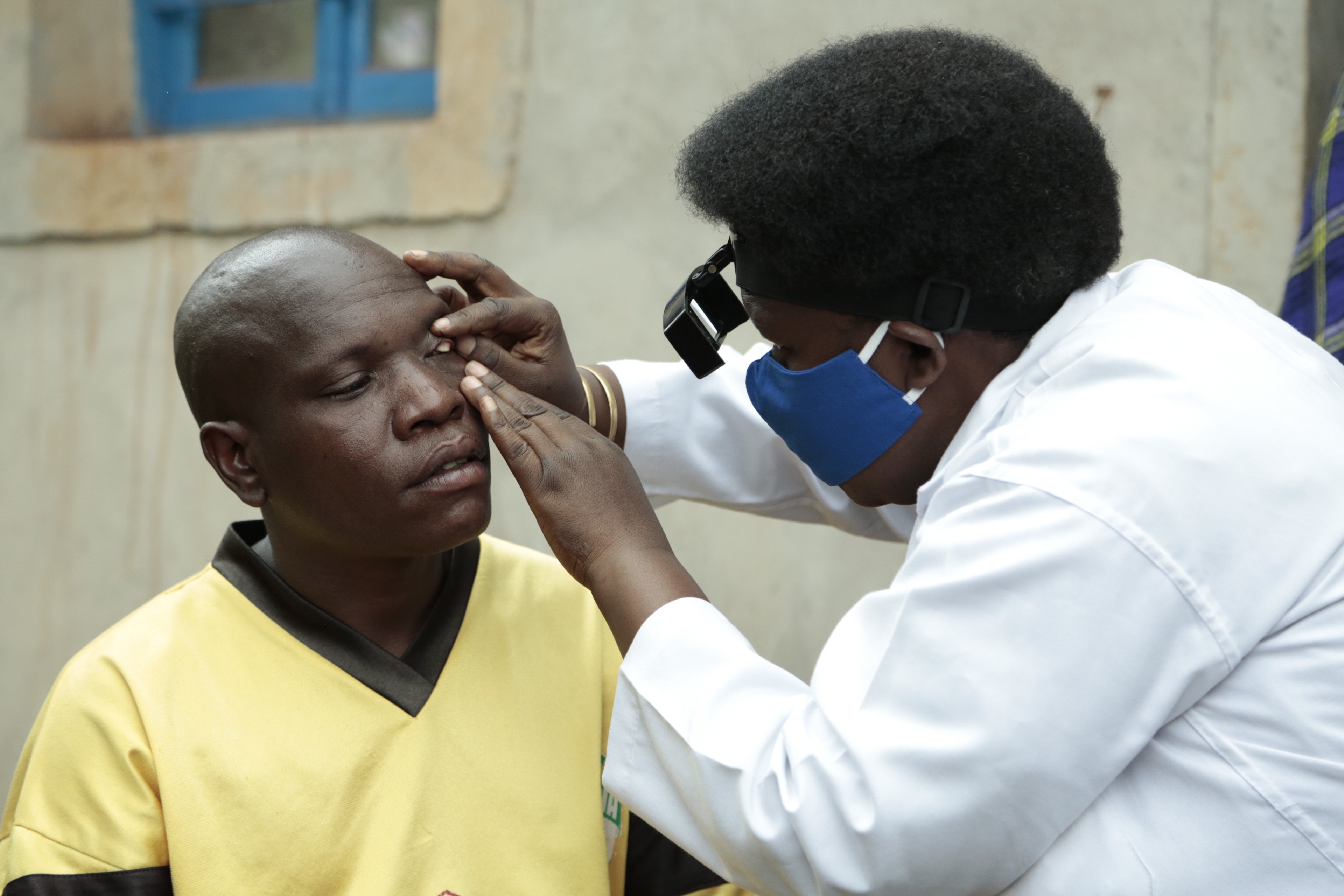 A doctor examines a man's eye