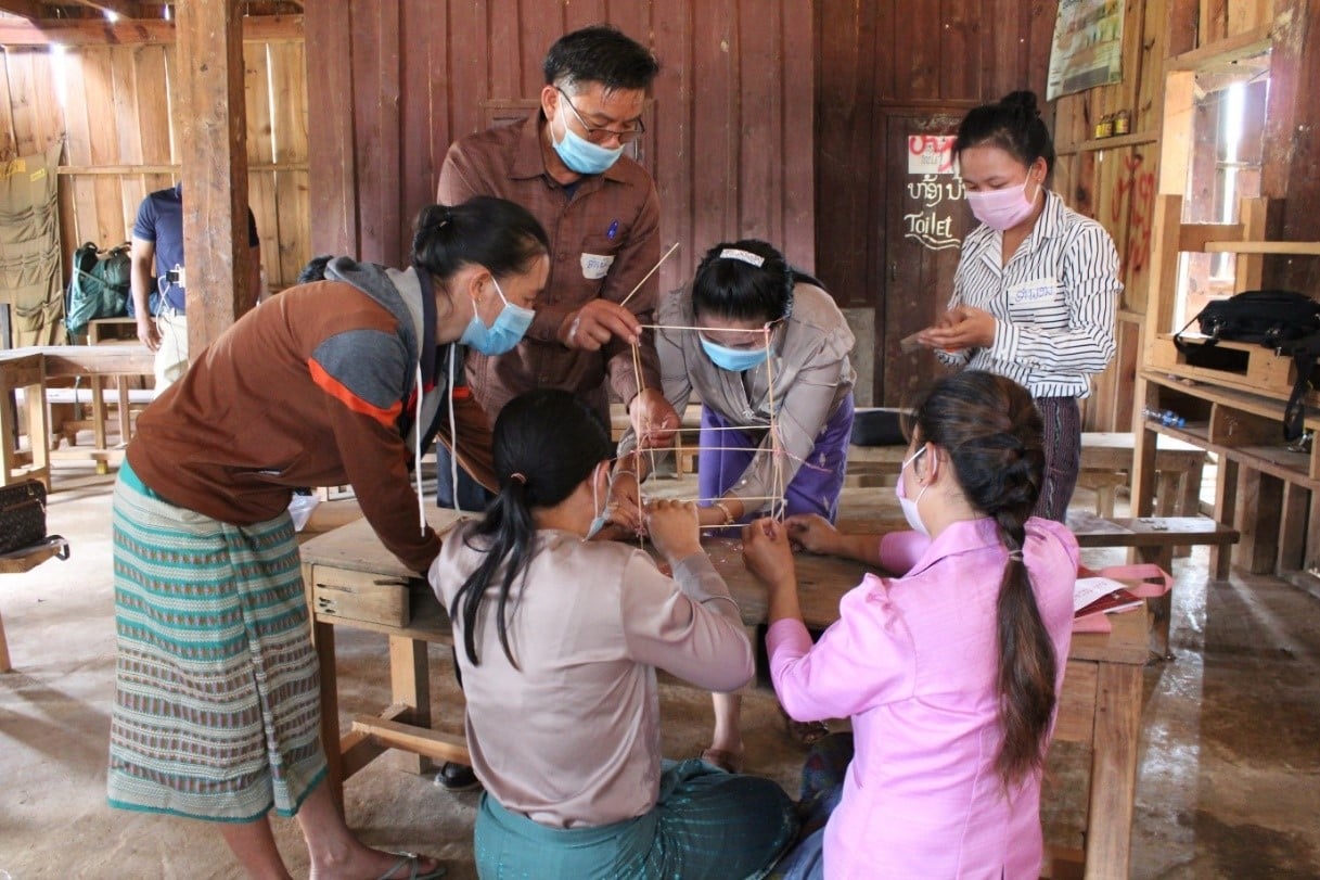 Workshop participants collaborate to build a “tower of good health”