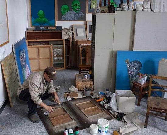 Art Fan Zhang works in his art studio in China